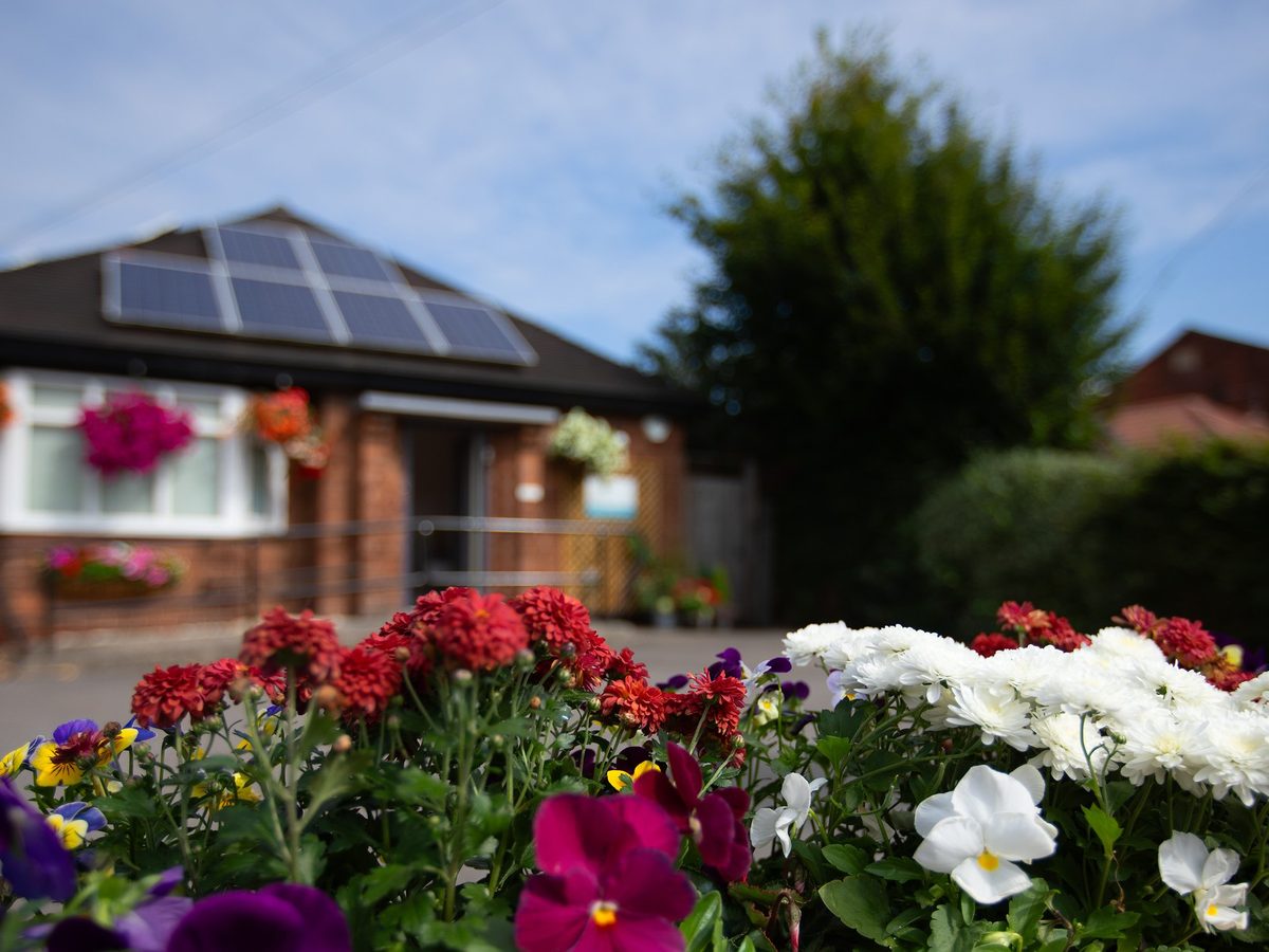 Exterior of Calm Dental Care with flower beds in front